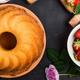 Aerial shot of bundt cake and a bowl of strawberries